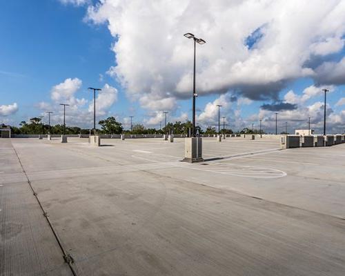 Exterior photo of top floor parking lot of parking garage.