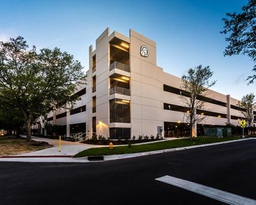 Exterior photo of Baptist parking structure's main corner mid-day.